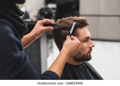 Male client getting haircut by hairdresser