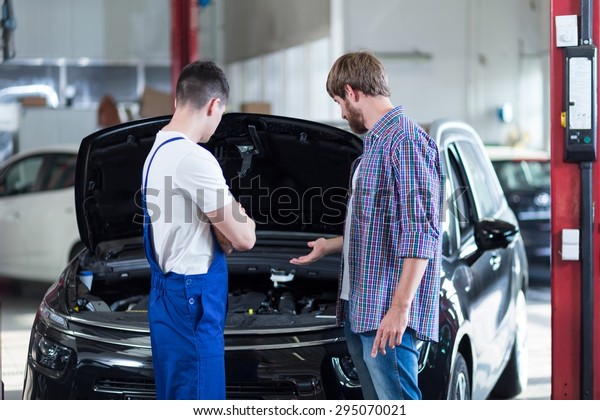 Male client having\
problem with car engine