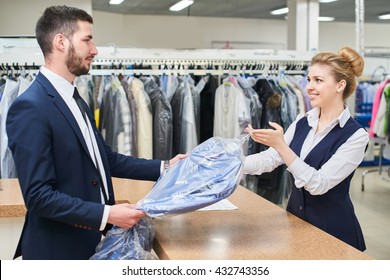 Male client takes a woman Laundry worker clean clothes at the dry cleaners