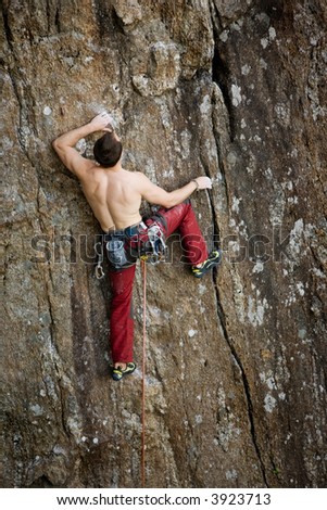 Similar – Rock climber clinging to a cliff.