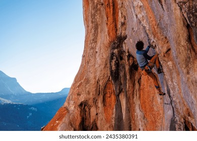 male climber. Athletic man climbing up an overhanging rock with a rope. rock climbing in Turkey. outdoor sports and recreation - Powered by Shutterstock