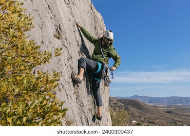 Male climber picking gear on waist