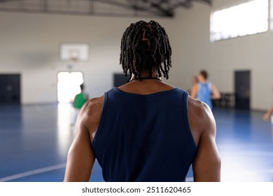 Male coach watching female basketball team playing, focusing on game on indoor court. exercise, fitness, competition, active - Powered by Shutterstock