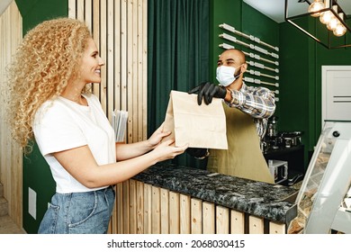 Male Coffee Shop Worker Giving Ready Order To The Client Wearing Face Mask