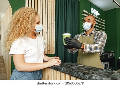 Male Coffee Shop Worker Giving Ready Order To The Client Wearing Face Mask