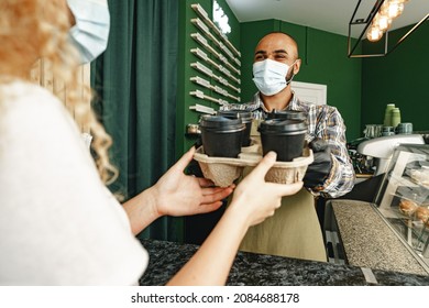 Male Coffee Shop Worker Giving Ready Order To The Client Wearing Face Mask