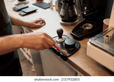 Male Coffeeshop Owner Cleaning Up Counter For Service To Customer. Close Up