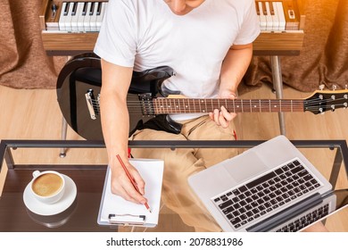 Male Composer, Songwriter Enjoy Writing Hit Song While Playing Black Electric Guitar In Home Studio. Songwriting Concept