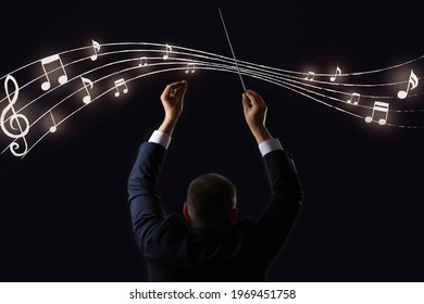 Male Conductor And Note Signs On Dark Background