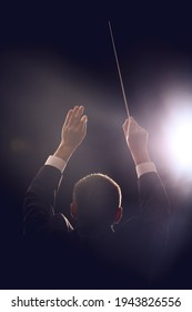 Male Conductor On Dark Background, Back View