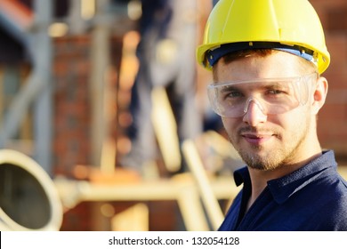 Male Construction Worker Smiling At A Building Site