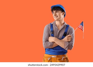 Male construction worker with USA flag on orange background - Powered by Shutterstock