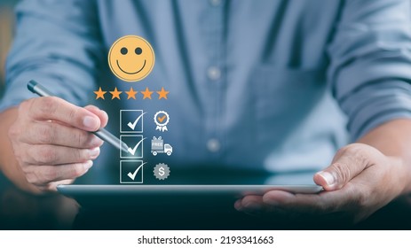 Male Consumers Use Tablets To Assess Their Satisfaction And Provide Ratings And Reviews Online. Customer Experience Survey Concepts For Services And Products And Customer Engagement