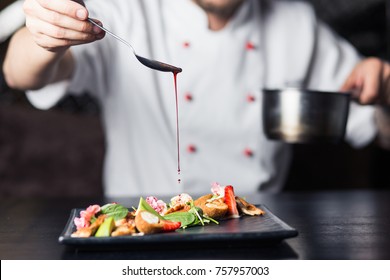 Male cook serve delicious steak on the cutting board at street cafe - Shutterstock ID 757957003