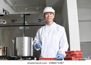 Male cooking staff packing food into bento boxes - Powered by Shutterstock