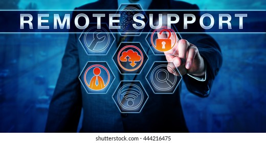 Male Corporate IT Technician Is Pressing REMOTE SUPPORT On An Interactive Touch Screen Monitor. Business Metaphor And Information Technology Concept For Desktop Sharing With A Distant IT Help Desk. 