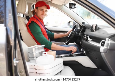 Male Courier With Orders In Car. Food Delivery Service