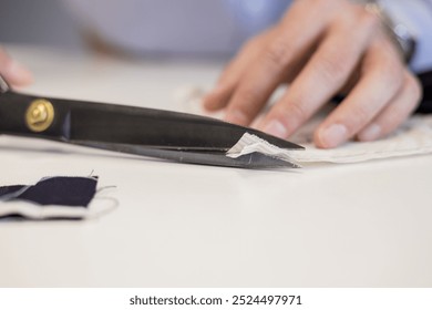 male craftsman cutting fabric by scissors at workshop. Fashion and hand craft concept. - Powered by Shutterstock