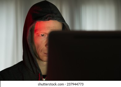 Male with criminal intentions at a computer on the internet.