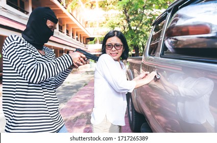 Male Criminals Currently Using A Carbine To Rob Women Which Is About To Open The Pickup Truck Door, To Bundits And Weapons Concept.