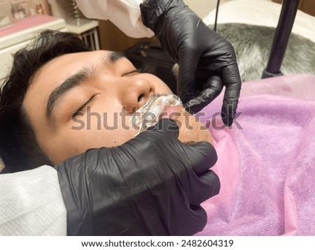 Similar – Image, Stock Photo Anonymous tattoo artist applying transfer paper on client’s back