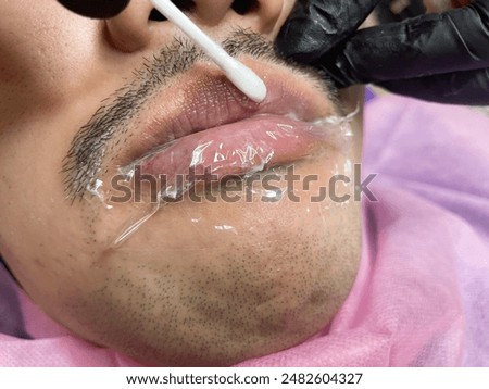 Similar – Image, Stock Photo Anonymous tattoo artist applying transfer paper on client’s back