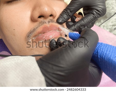Similar – Image, Stock Photo Anonymous tattoo artist applying transfer paper on client’s back