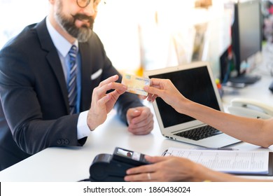 Male Customer Making Payment Using Credit Card At Car Maintenance Station And Automobile Service Garage