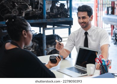 Male customers paying by credit card at counter in auto parts stores. business warehouse motor vehicle. - Powered by Shutterstock