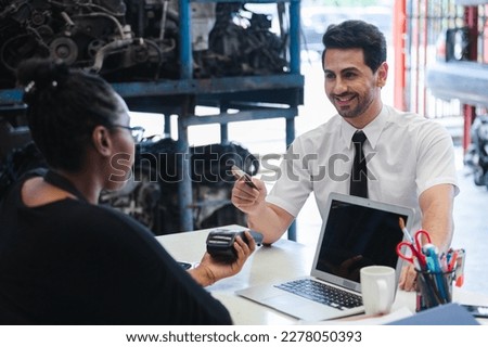 Male customers paying by credit card at counter in auto parts stores. business warehouse motor vehicle.