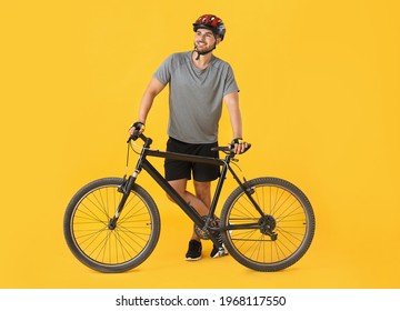 Male Cyclist With Bicycle On Color Background