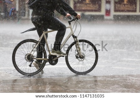 male cyclist in heavy rain