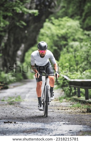 A male cyclist on a racing bike on a mountain road