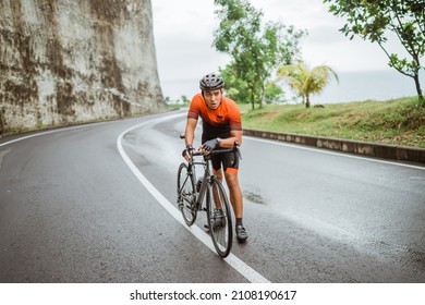 Male Cyclist Pushing His Bike And Walk After Struggling To Climb