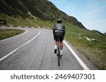 Male cyclist is riding gravel bike on Transfagarasan road. A cyclist is practicing cycling.Sport motivation.Adventure travel on bike.Mountain background.Cycling in Carpathian Mountains. Transfăgărășan