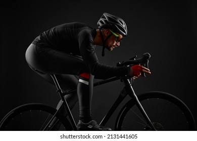 Male Cyclist Riding Road Bicycle On Black Background