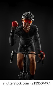 Male Cyclist Riding Road Bicycle On Black Background