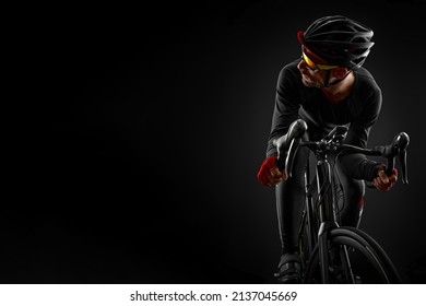 Male Cyclist Riding Road Bicycle On Black Background