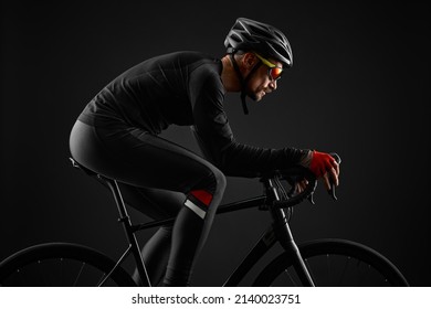 Male Cyclist Riding Road Bicycle On Black Background