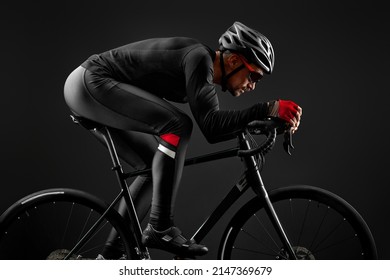 Male Cyclist Riding Road Bicycle On Black Background