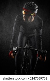 Male Cyclist Riding Road Bicycle On Black Background