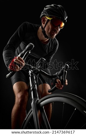 Similar – Man on bicycle preparing for triathlon race