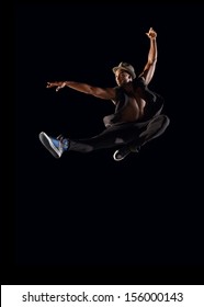 Male Dancer Leaping On Black Background