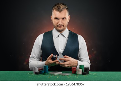 Male dealer at the casino at the table. Casino concept, gambling, poker, chips on the green casino table - Shutterstock ID 1986478367