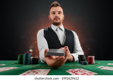 Male dealer at the casino at the table. Casino concept, gambling, poker, chips on the green casino table - Shutterstock ID 1992629612