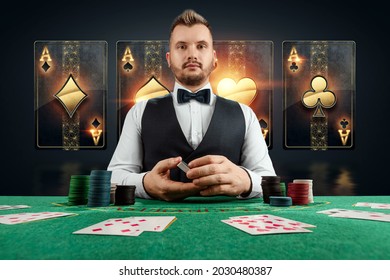 Male dealer at the casino at the table. Casino concept, gambling, poker, chips on the green casino table - Shutterstock ID 2030480387