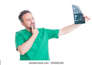 Male Dentist Analyzing Denture Xray After Dental Implant