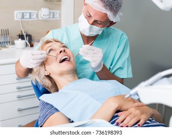 Male Dentist With Female Patient During Oral Checkup In Dentistry