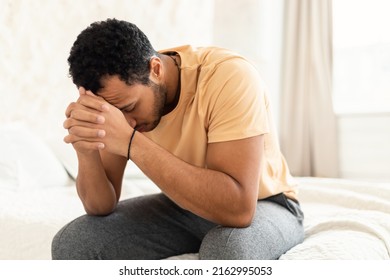 Male Depression. Unhappy Middle Eastern Guy Covering Face Having Stress And Problems Sitting In Bedroom At Home. Unrecognizable Man Suffering From Depressing Thoughts. Mental Health Concept - Shutterstock ID 2162995053