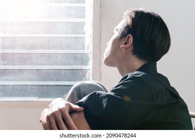 Male depression. Upset Asian young man got problem sitting alone at home, a lot of thoughts, break up with a lover or bad time financial and debt Overthinking Unhappy unsatisfied and trouble idea.